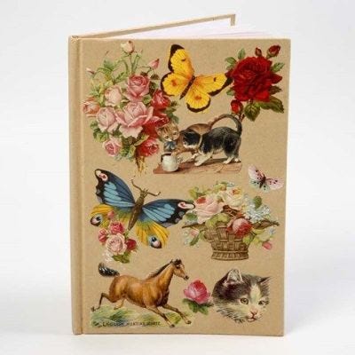 Een notitieboek met een collage van vintage Die-Cuts